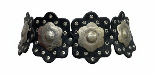 Black leather belt with silver floral conchos on a white background