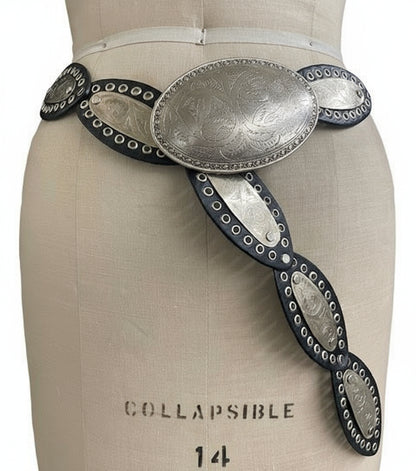 Decorative belt with metallic buckle on a mannequin torso.